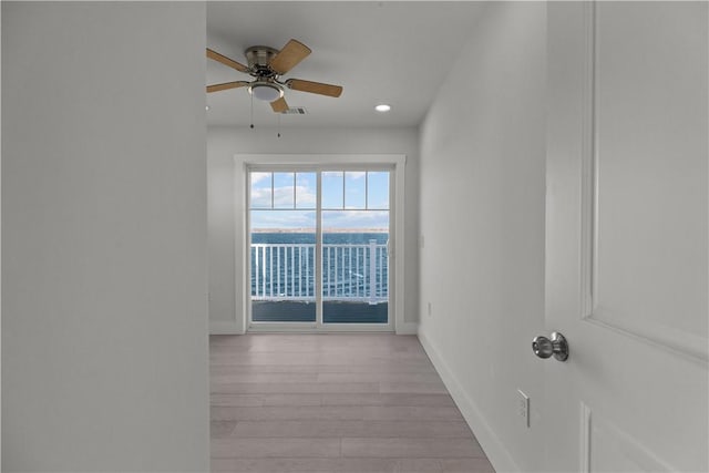 empty room featuring visible vents, baseboards, recessed lighting, wood finished floors, and ceiling fan