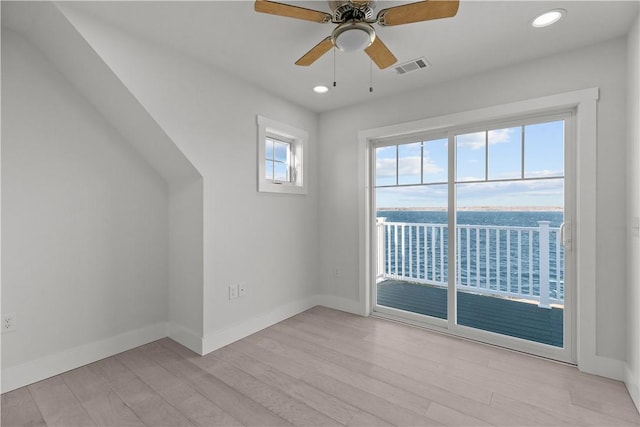 empty room featuring baseboards, light wood-style flooring, visible vents, and ceiling fan
