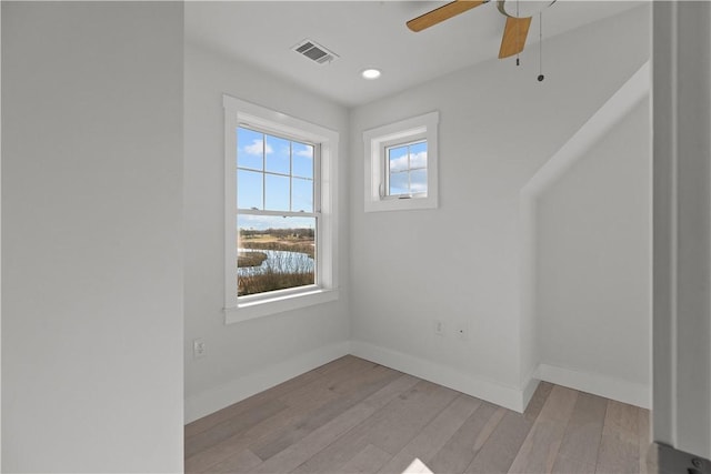 spare room featuring light wood-type flooring, ceiling fan, baseboards, visible vents, and recessed lighting