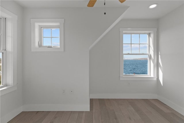additional living space with baseboards, a ceiling fan, wood finished floors, and recessed lighting