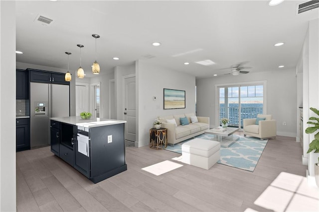 kitchen featuring built in fridge, light wood-style flooring, visible vents, and recessed lighting