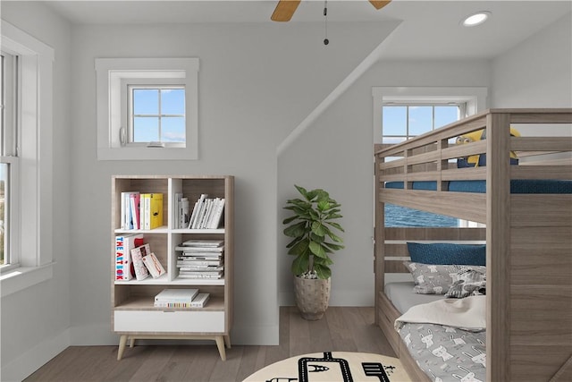 bedroom featuring recessed lighting, wood finished floors, baseboards, and ceiling fan