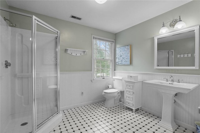 10 David Ct, East Greenwich, RI 02818 - full bathroom with wainscoting, a shower stall, toilet, and visible vents