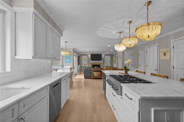 10 David Ct, East Greenwich, RI 02818 - kitchen featuring tasteful backsplash, a chandelier, light wood-type flooring, stainless steel appliances, and white cabinets
