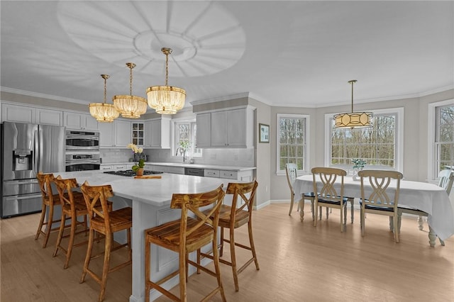 10 David Ct, East Greenwich, RI 02818 - dining room featuring light wood-type flooring, crown molding, and a notable chandelier
