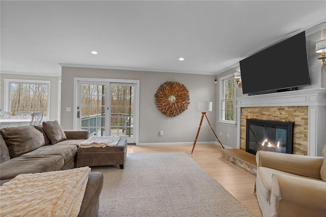 10 David Ct, East Greenwich, RI 02818 - living area featuring recessed lighting, light wood finished floors, a stone fireplace, crown molding, and baseboards