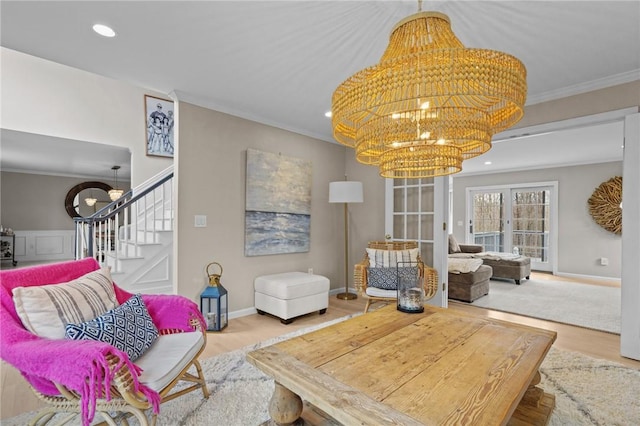 10 David Ct, East Greenwich, RI 02818 - living area with wood finished floors, a notable chandelier, stairs, and ornamental molding