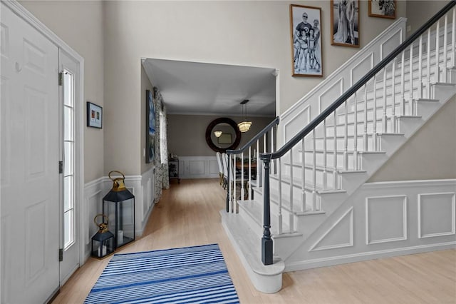 10 David Ct, East Greenwich, RI 02818 - staircase with wood finished floors, a wainscoted wall, and a decorative wall
