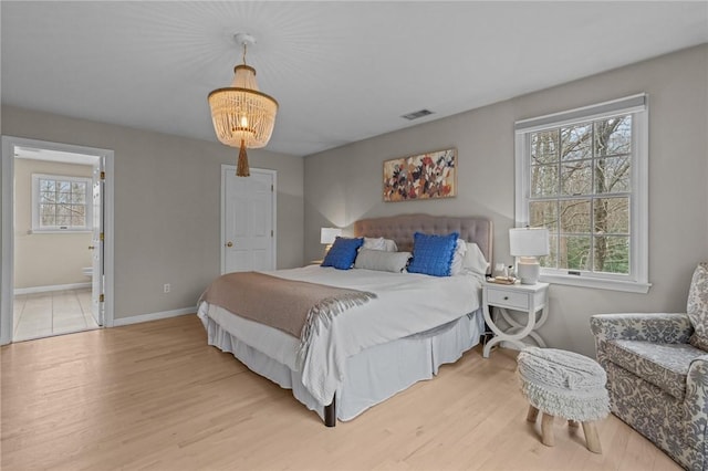 10 David Ct, East Greenwich, RI 02818 - bedroom with visible vents, light wood-type flooring, a notable chandelier, and baseboards