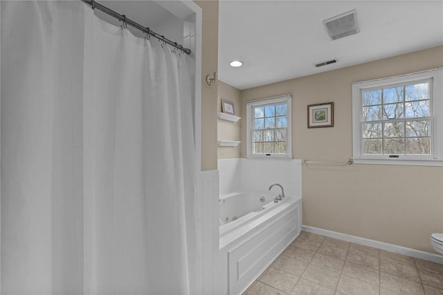 10 David Ct, East Greenwich, RI 02818 - bathroom with baseboards, visible vents, toilet, and a garden tub