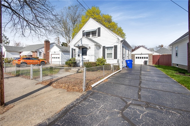 39 Hillview Ave, Providence, RI 02908 - bungalow-style house with a garage, driveway, a fenced front yard, and an outdoor structure