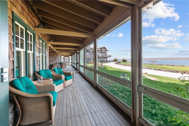 sunroom / solarium with a water view