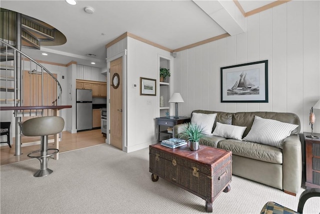 living area with light carpet, crown molding, and stairs