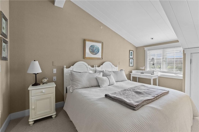 bedroom with lofted ceiling, baseboards, and carpet flooring