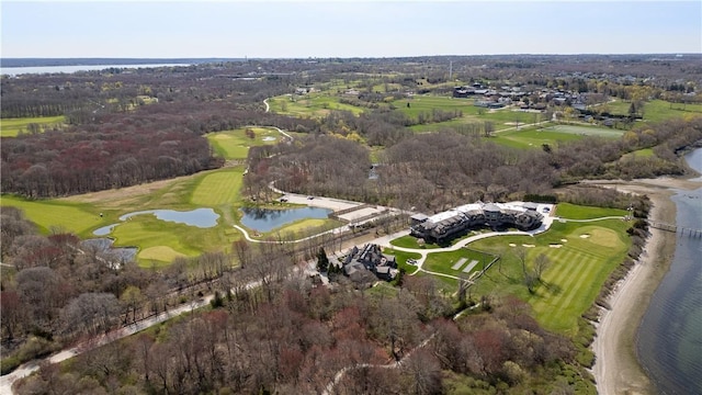 drone / aerial view featuring golf course view and a water view
