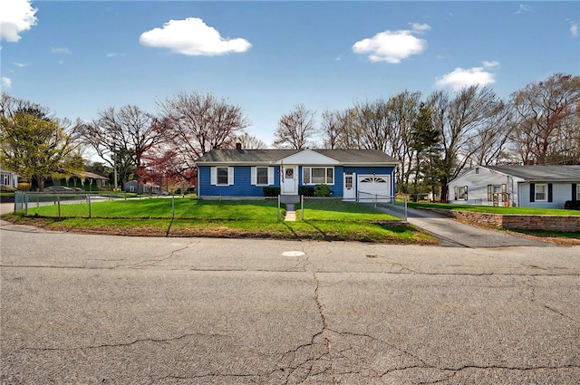 view of front facade featuring a front lawn, aphalt driveway, a chimney, an attached garage, and a fenced front yard