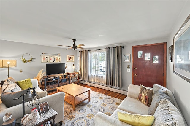 living room featuring wood finished floors, a ceiling fan, and a baseboard heating unit