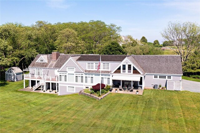 29 Reliance Dr, Bristol, RI 02809 - rear view of property featuring a patio area, a lawn, an outdoor structure, and a shed