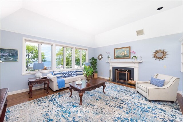 29 Reliance Dr, Bristol, RI 02809 - living area with lofted ceiling, baseboards, wood finished floors, and a wealth of natural light