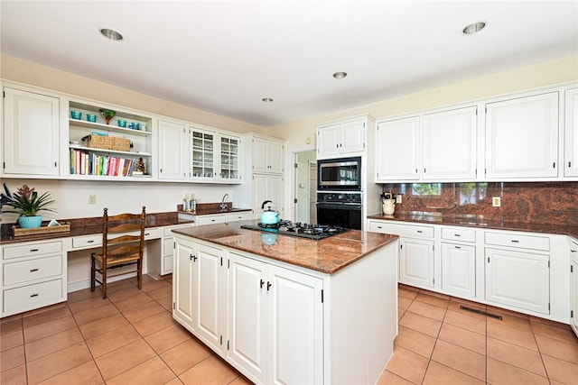 29 Reliance Dr, Bristol, RI 02809 - kitchen with built in study area, oven, light tile patterned floors, stainless steel microwave, and gas cooktop
