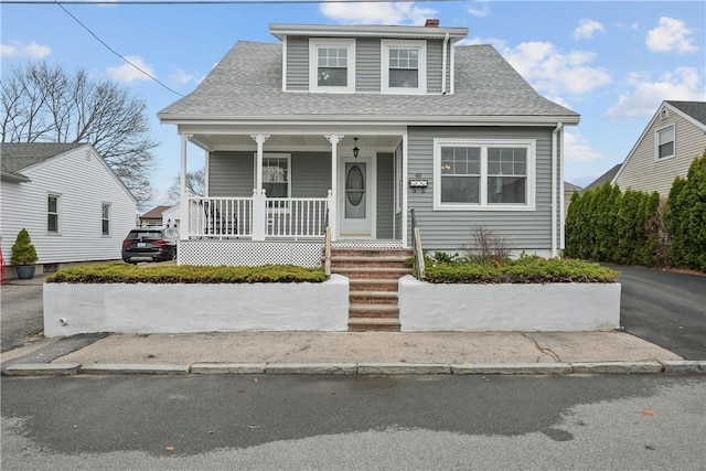view of front of home featuring covered porch and roof with shingles