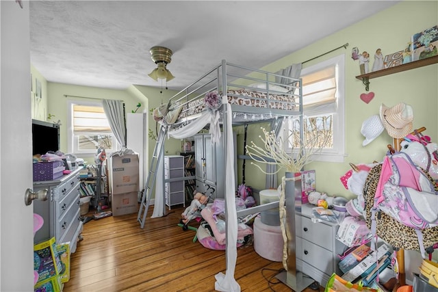 bedroom with wood finished floors and ceiling fan