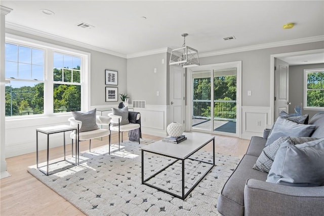 0 Greenwich Blvd Unit 203, East Greenwich, RI 02818 - living area with a chandelier, light wood-type flooring, crown molding, a decorative wall, and wainscoting