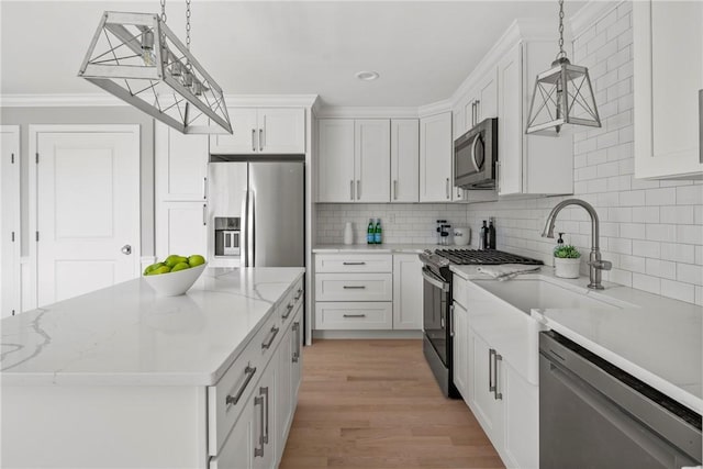 0 Greenwich Blvd Unit 203, East Greenwich, RI 02818 - kitchen with appliances with stainless steel finishes, decorative backsplash, white cabinetry, a center island, and hanging light fixtures