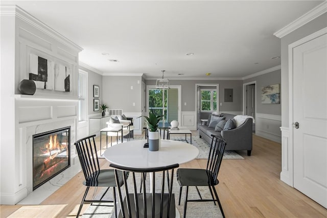 0 Greenwich Blvd Unit 203, East Greenwich, RI 02818 - dining space featuring light wood finished floors, a premium fireplace, electric panel, wainscoting, and ornamental molding