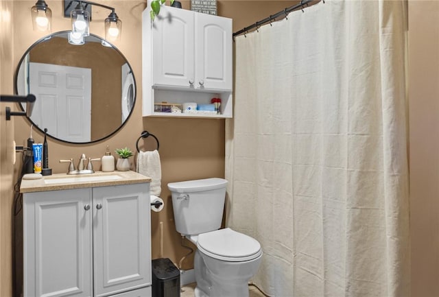 bathroom featuring vanity, curtained shower, and toilet