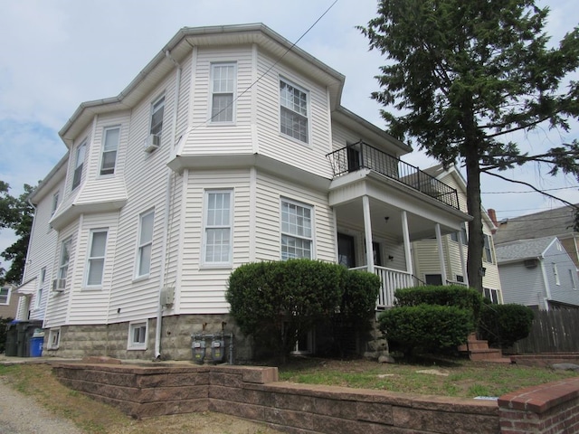view of front of home with a porch and a balcony