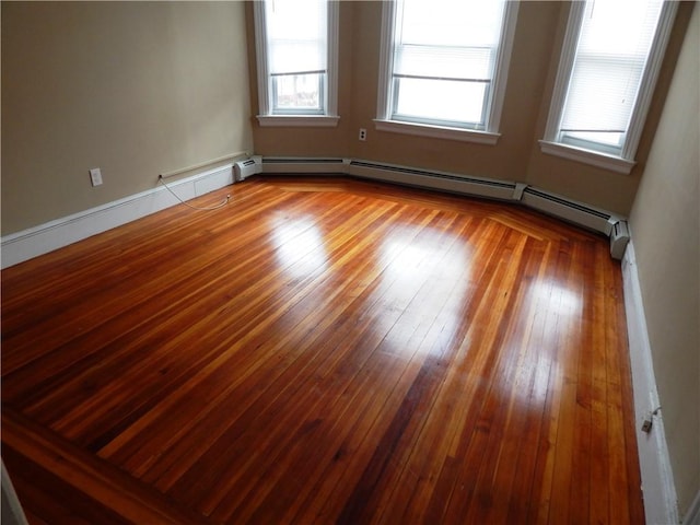 unfurnished room with hardwood / wood-style floors and a healthy amount of sunlight