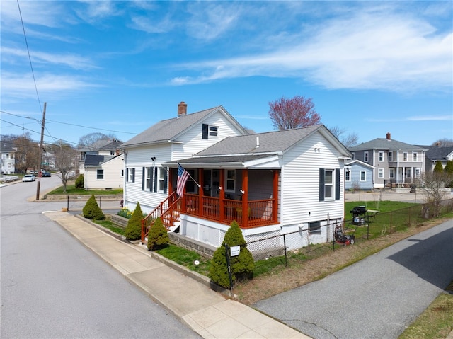 27 Pond St, West Warwick, RI 02893 - bungalow-style house with a residential view, covered porch, roof with shingles, and a fenced front yard