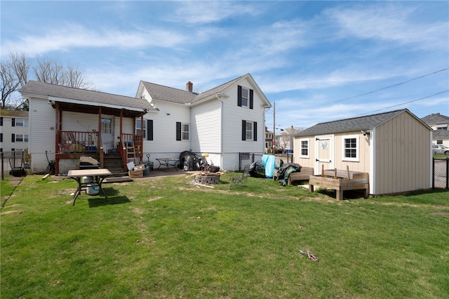 27 Pond St, West Warwick, RI 02893 - back of property featuring fence, a yard, an outdoor structure, a fire pit, and a deck