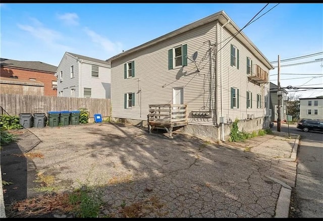 rear view of property featuring fence