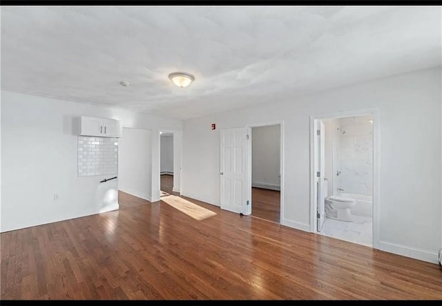 interior space with baseboards and wood finished floors