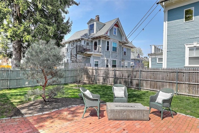view of patio featuring a fenced backyard and a fire pit