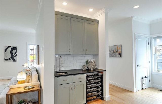 bar featuring crown molding, a sink, wine cooler, and a wealth of natural light