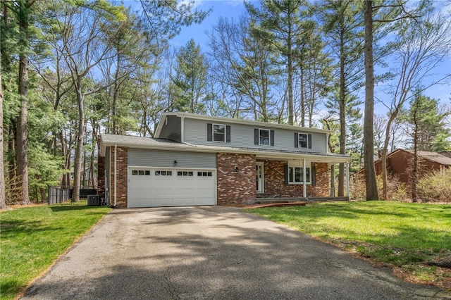 traditional-style house with a porch, a front lawn, driveway, and brick siding