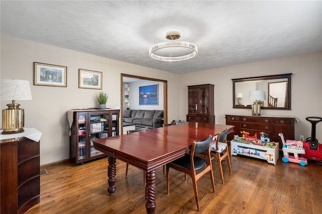 dining room with wood finished floors and baseboards