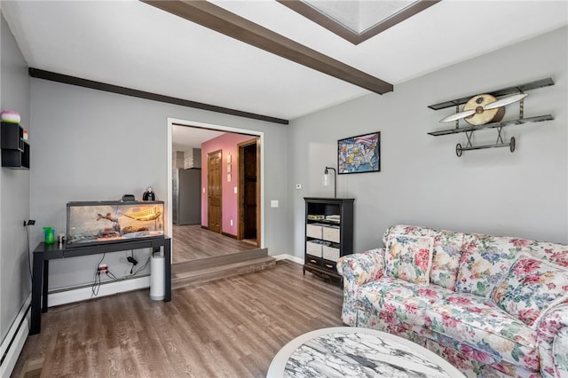 living room featuring a baseboard radiator, wood finished floors, baseboards, and beamed ceiling