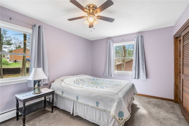 carpeted bedroom featuring a ceiling fan, baseboards, and a closet