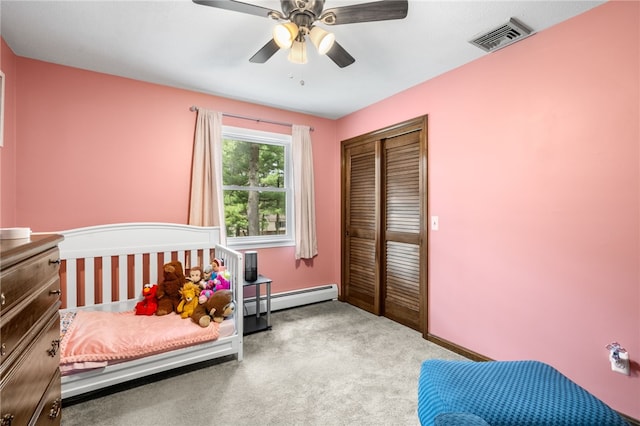 bedroom with a baseboard radiator, a closet, ceiling fan, carpet floors, and visible vents