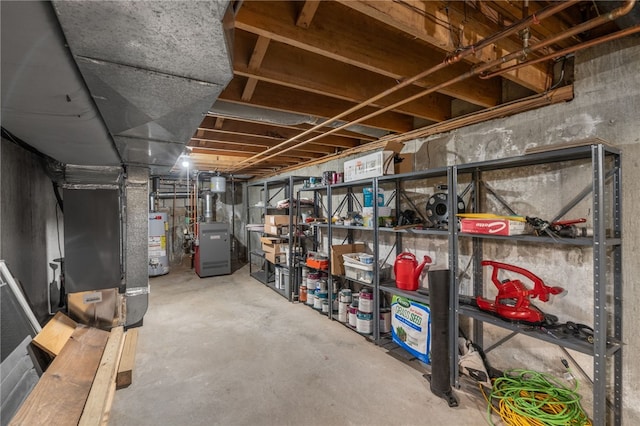 unfinished basement featuring gas water heater and a heating unit