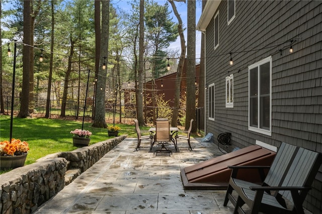 view of patio with outdoor dining area and fence