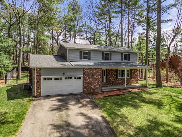 traditional-style home with brick siding, a front lawn, driveway, and a porch