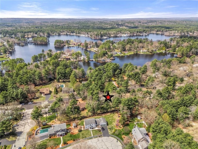 birds eye view of property with a water view and a wooded view
