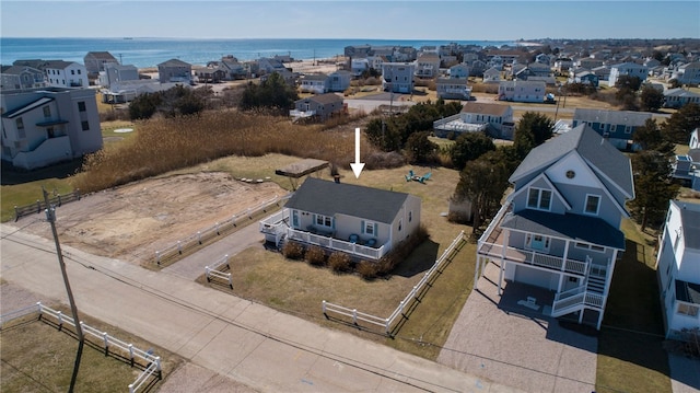 drone / aerial view with a water view and a residential view