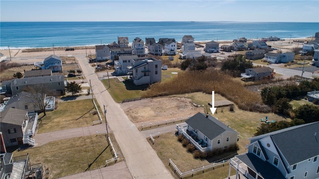 drone / aerial view with a residential view and a water view