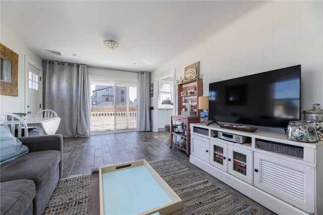 living room with wood finished floors, a healthy amount of sunlight, and visible vents